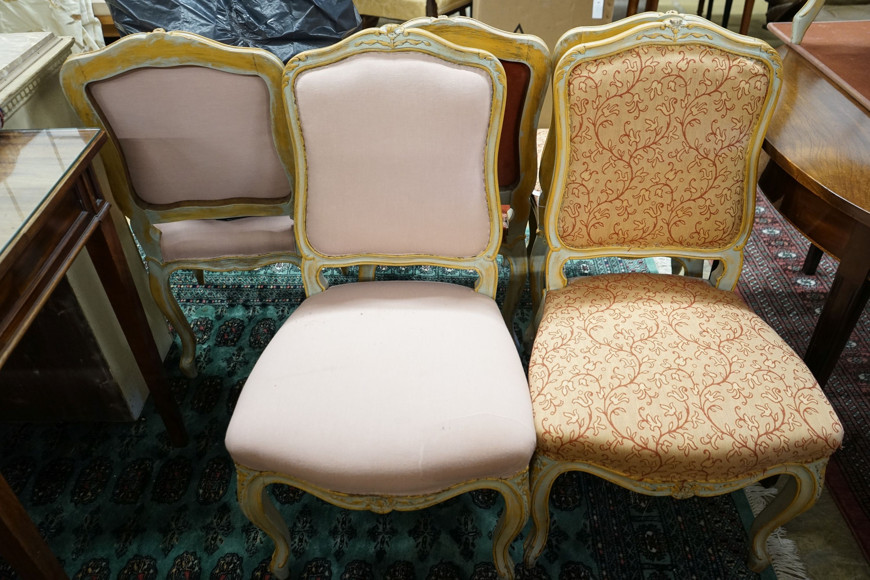 A set of fourteen French Louis XV style painted upholstered dining chairs with loose covers